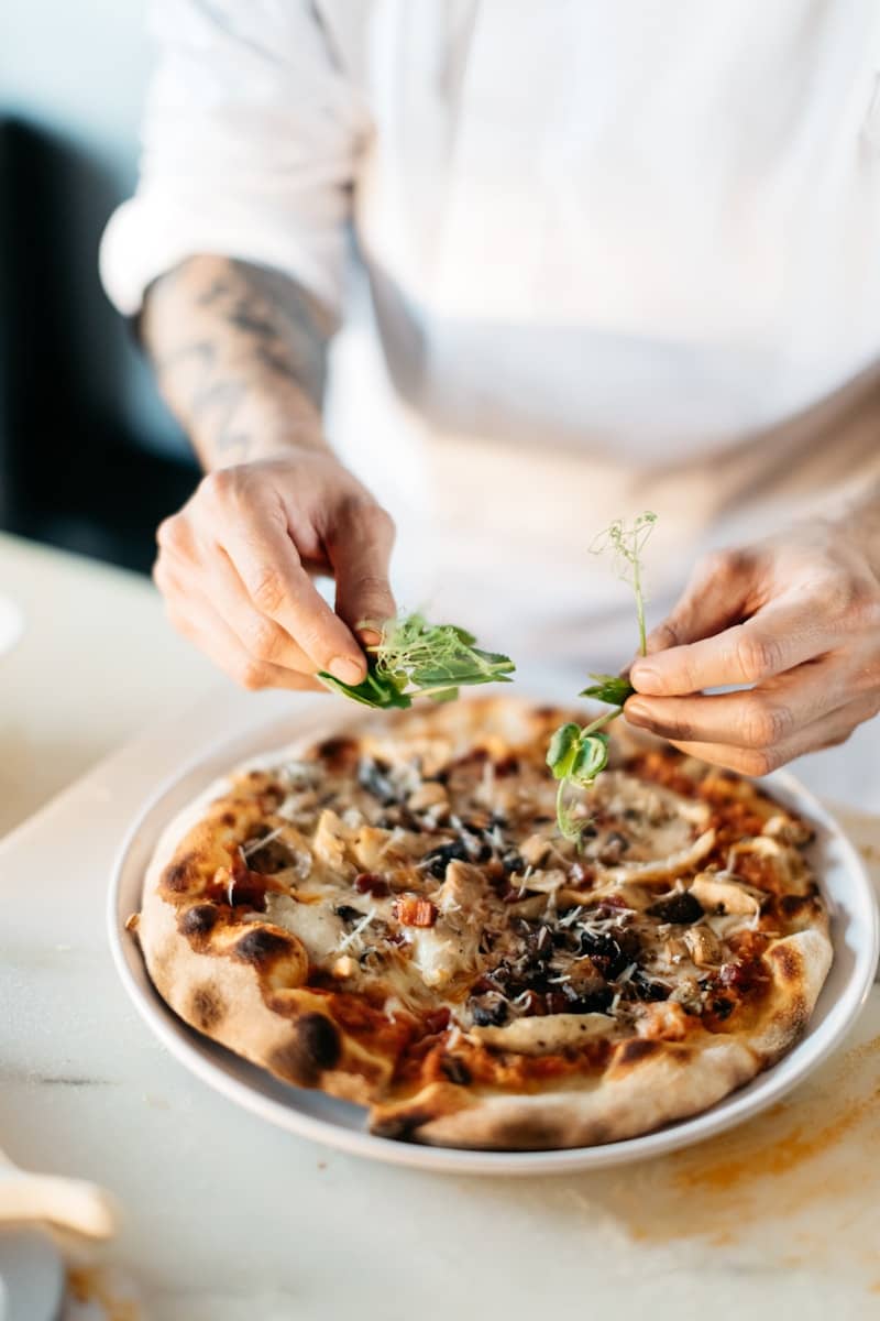 person preparing pizza