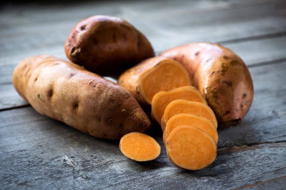 Whole and sliced sweet potatoes