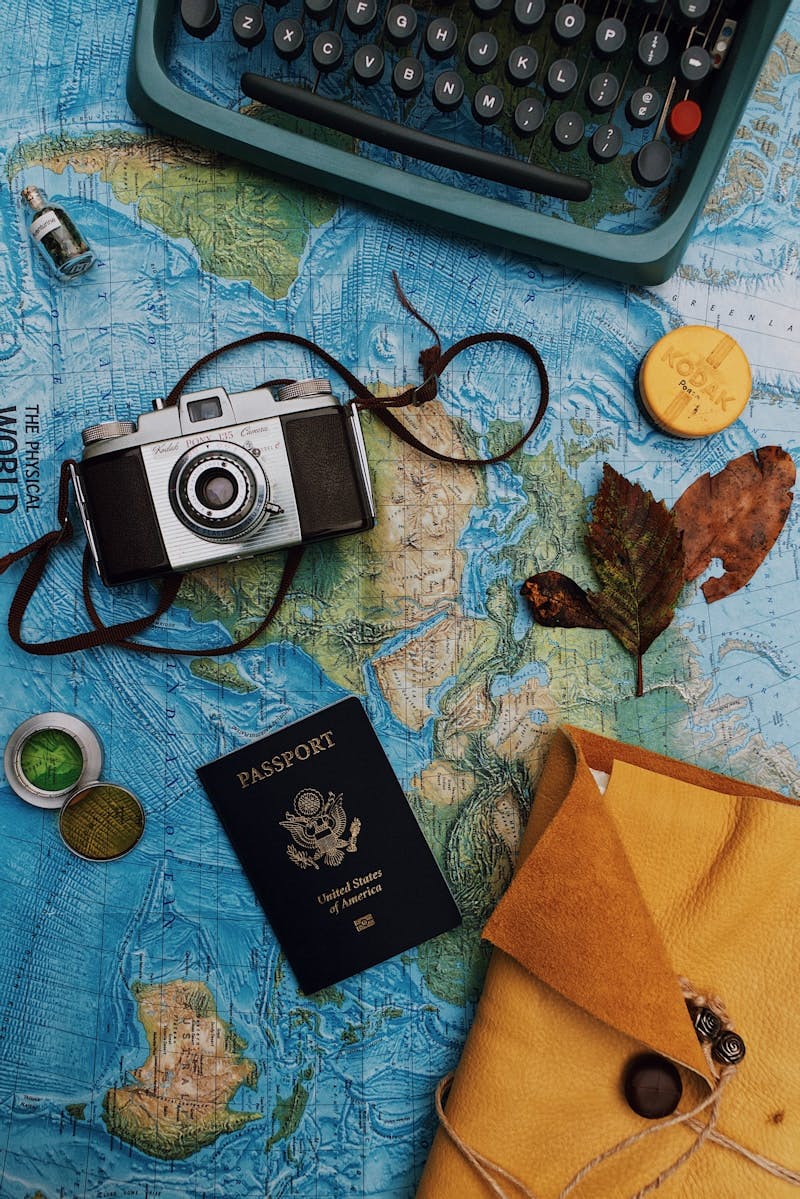 flatlay photography of camera, laptop, and passport