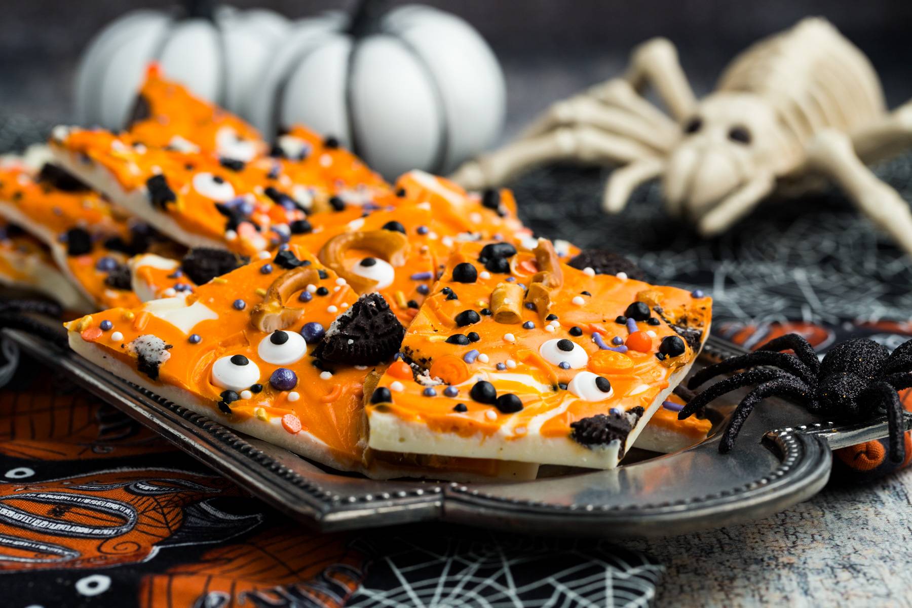 Randomly shaped broken pieces of Halloween bark on a platter.