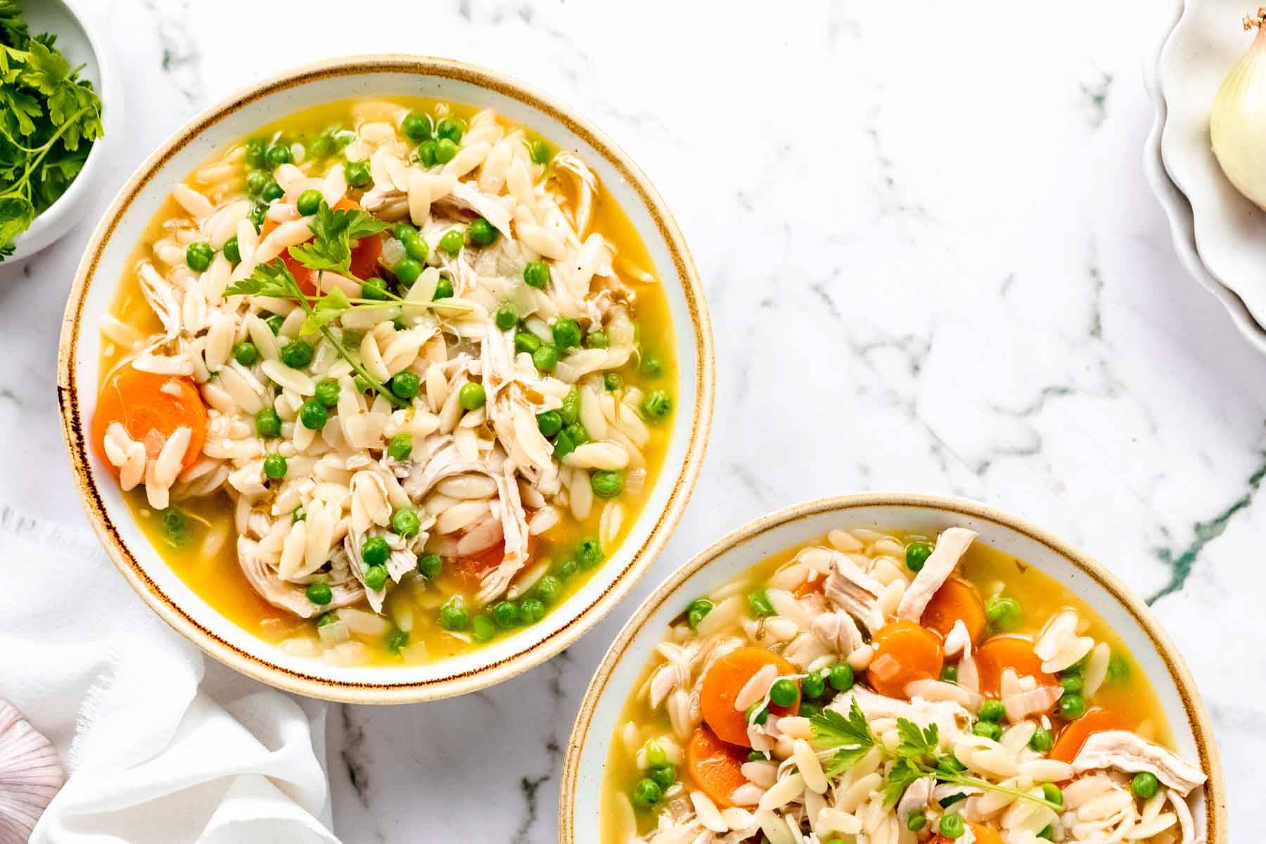 Two bowls of chicken orzo stew.