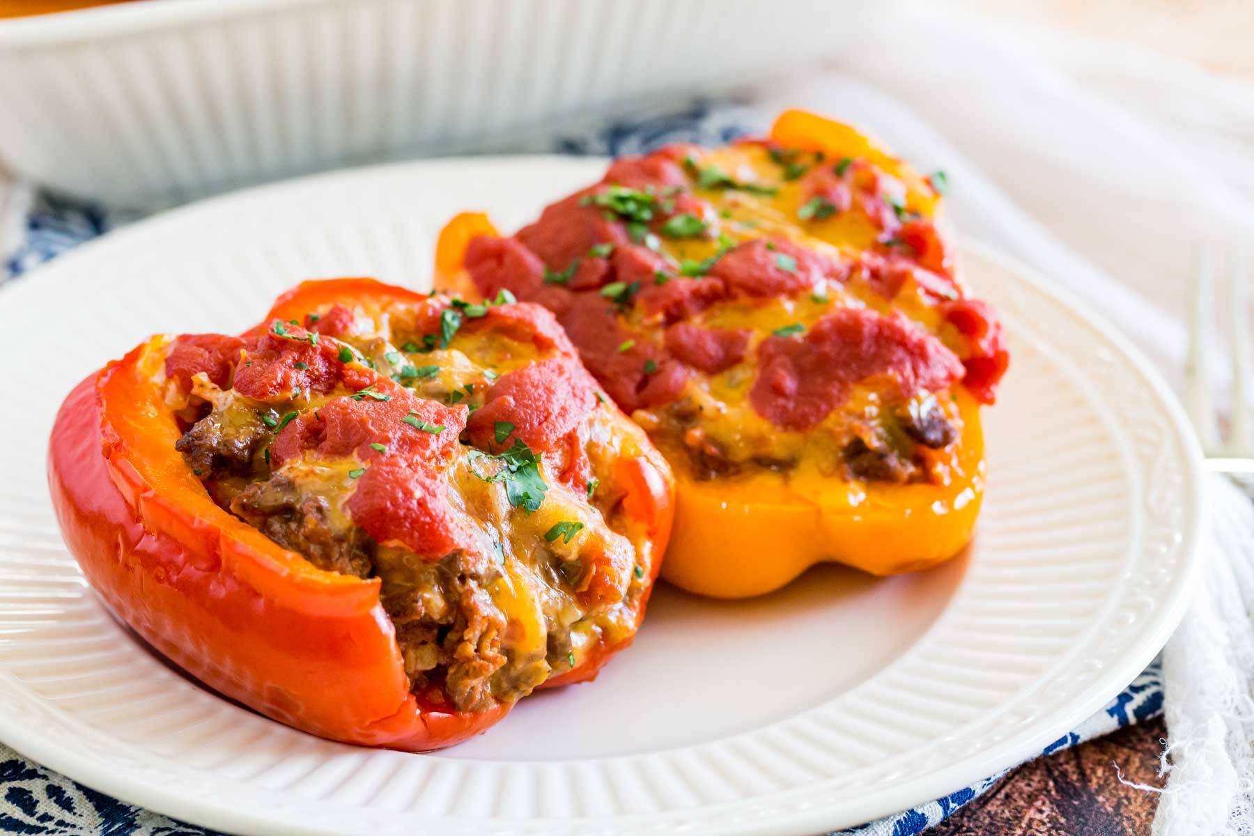 Two stuffed pepper halves on a plate.
