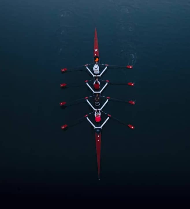 a row of boats floating on top of a body of water