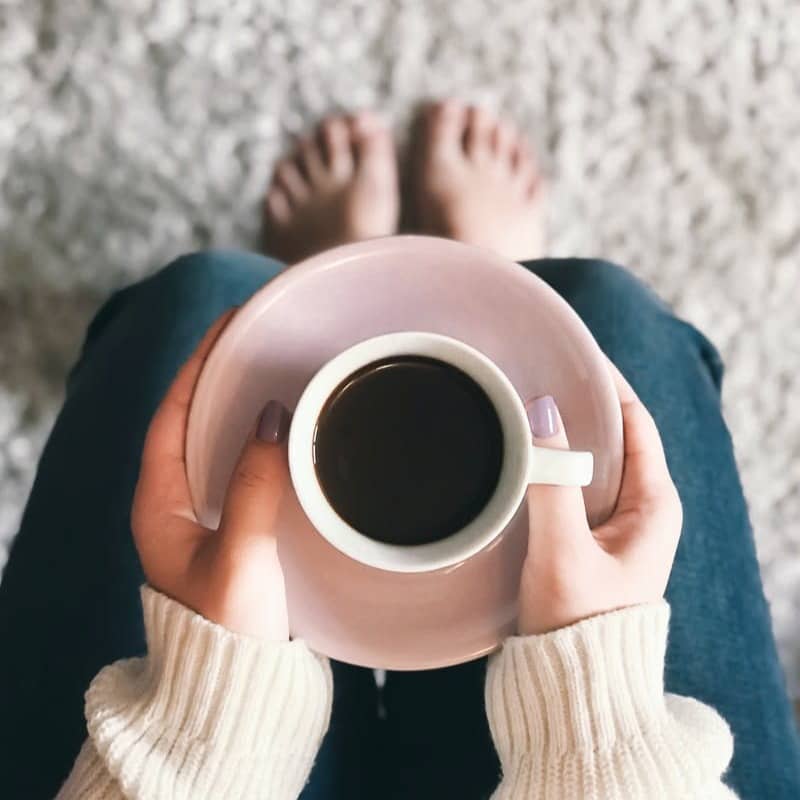 person holding cup of coffee