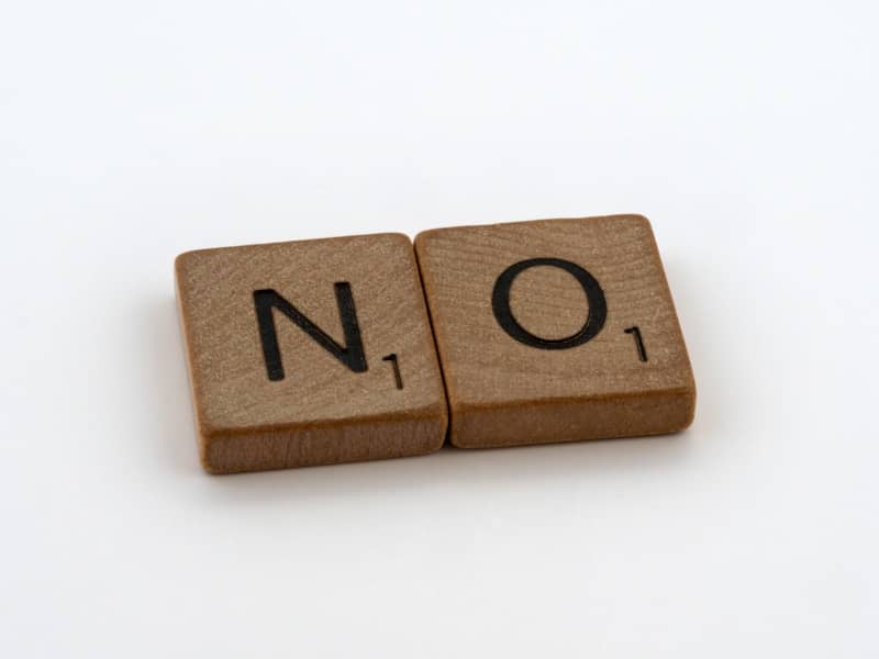 a wooden block with the word no on it