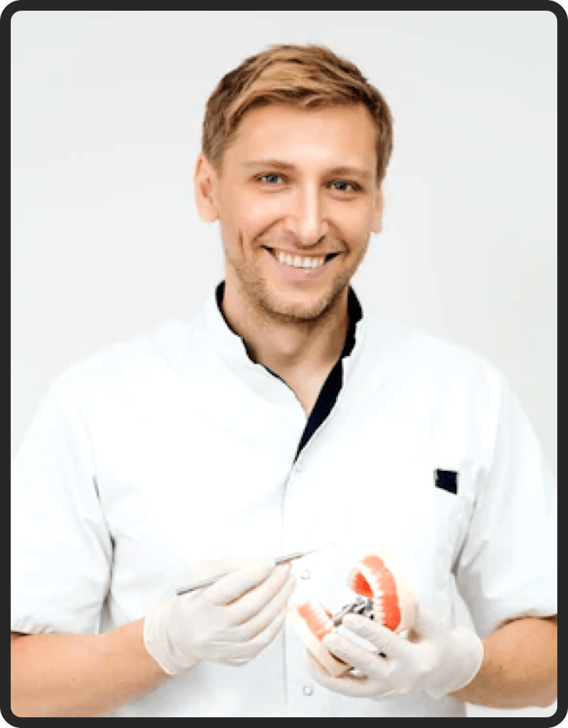 A dentistry professional holding a dental model