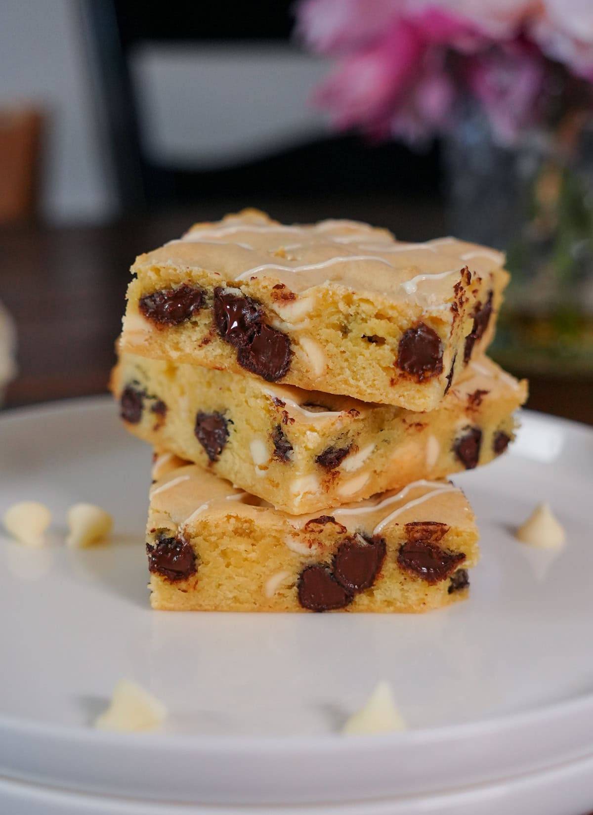 A stack of chocolate and white chocolate brownies on a plate. 
