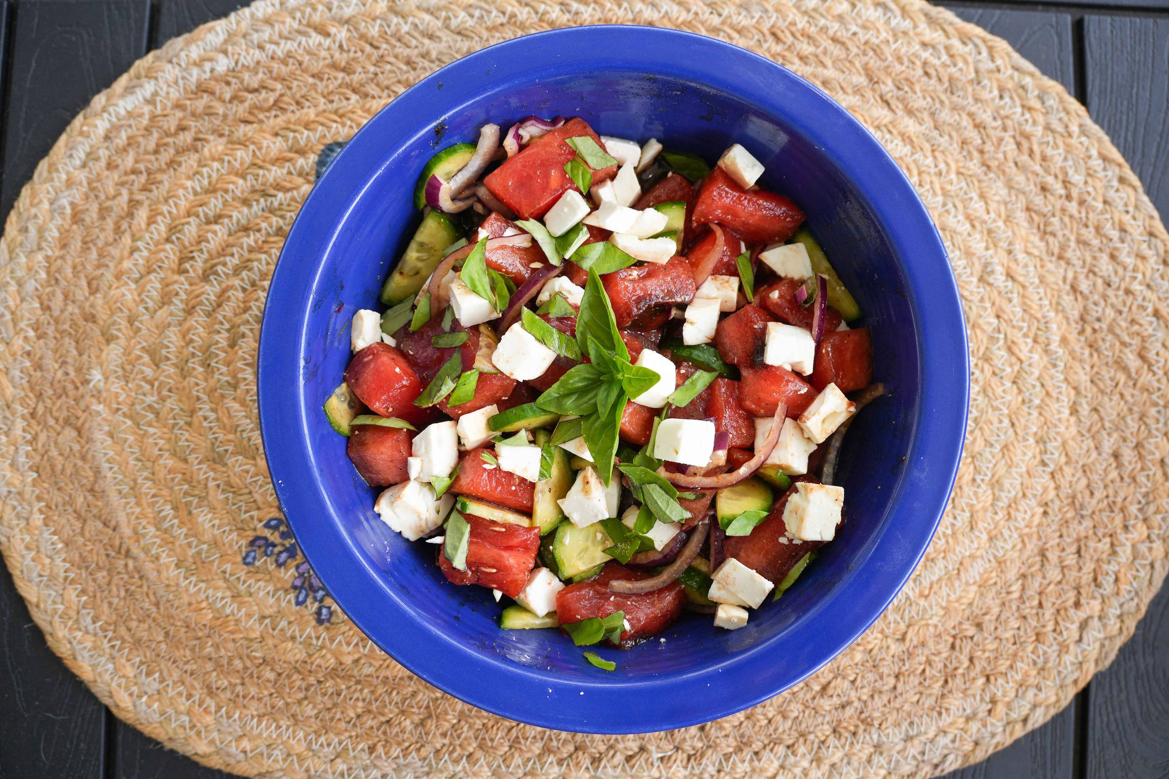 A bowl of grilled watermelon salad and feta cheese. 