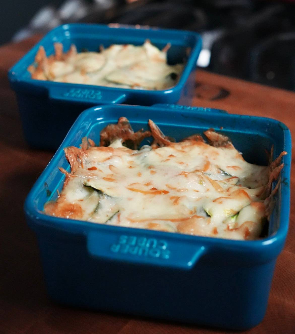 A serving of zucchini bake with melted cheese. 