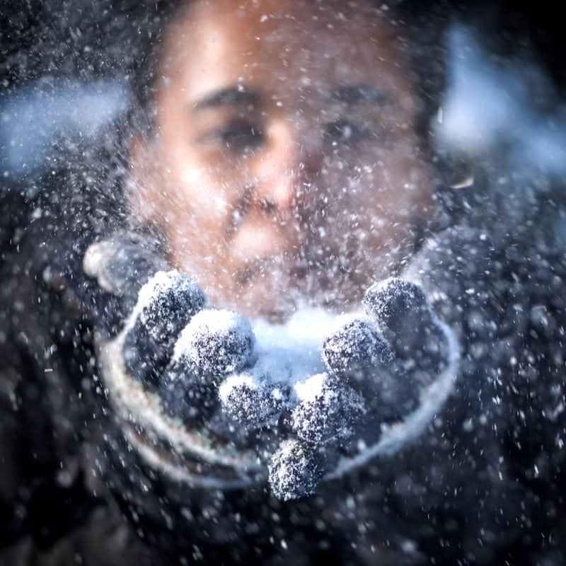 man blowing snow in time-lapse photography