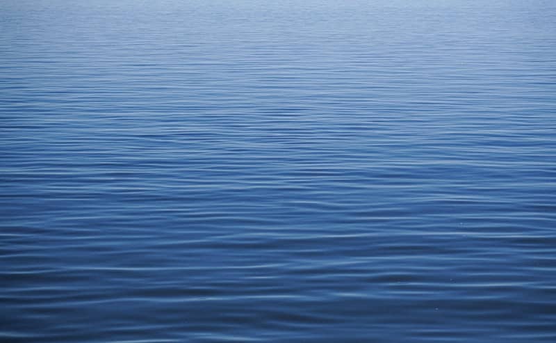 A large body of water with a sky in the background