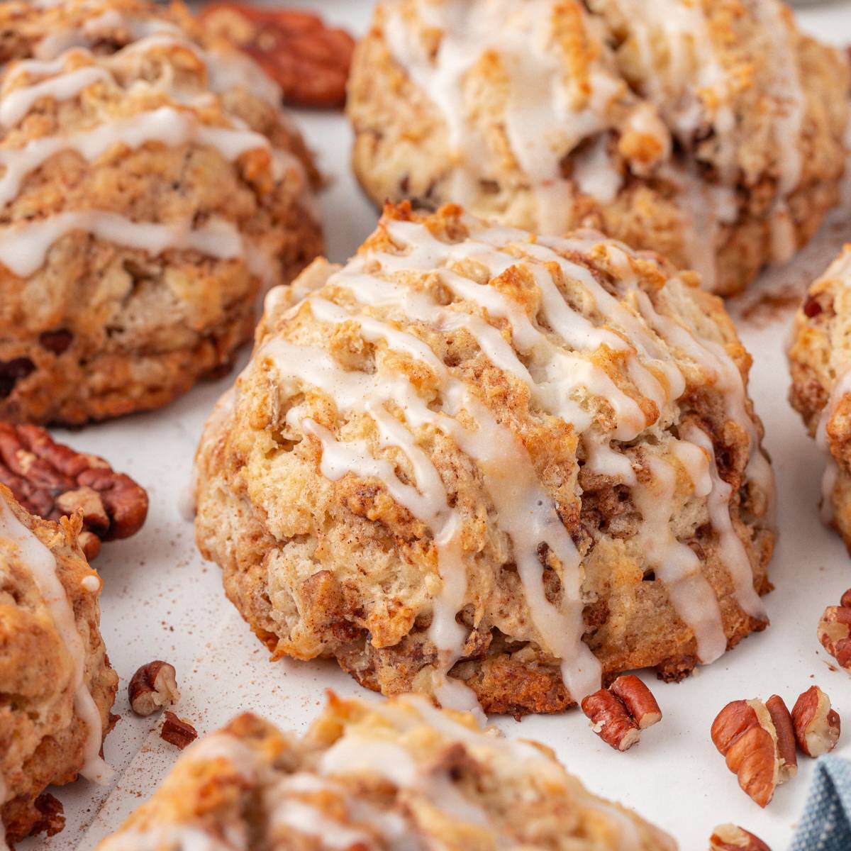 close up of a cinnamon bun scone drizzled with a sweet glaze