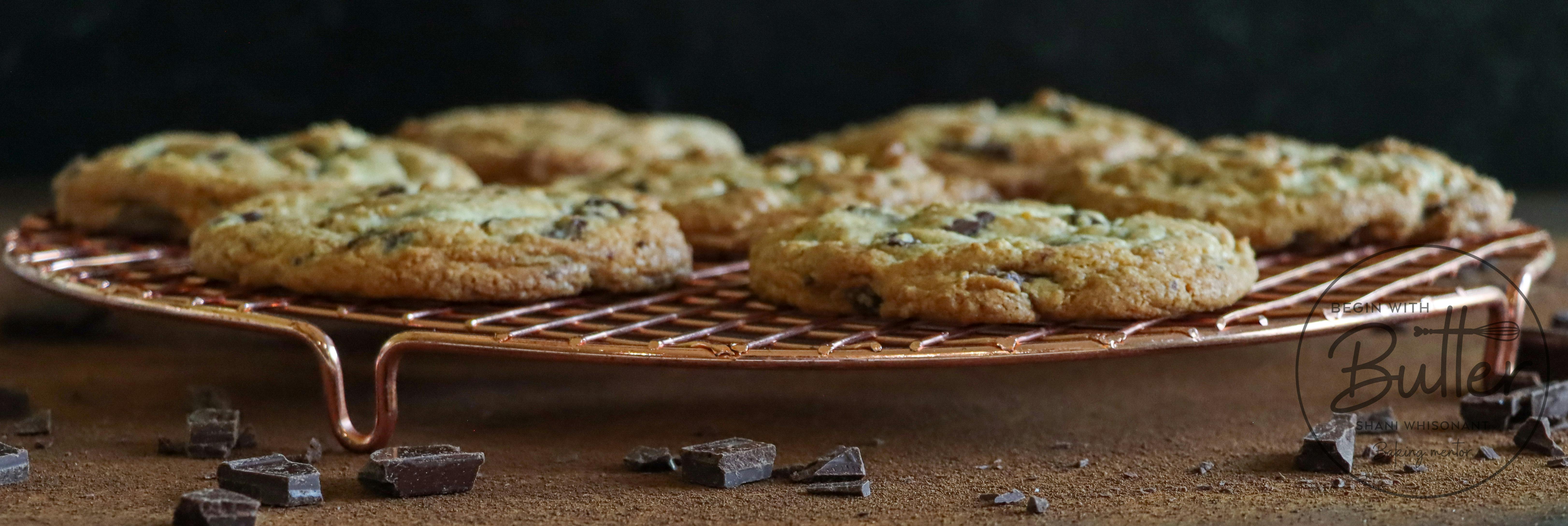 this is a side view of a cooling rack of oversized chocolate chip cookies