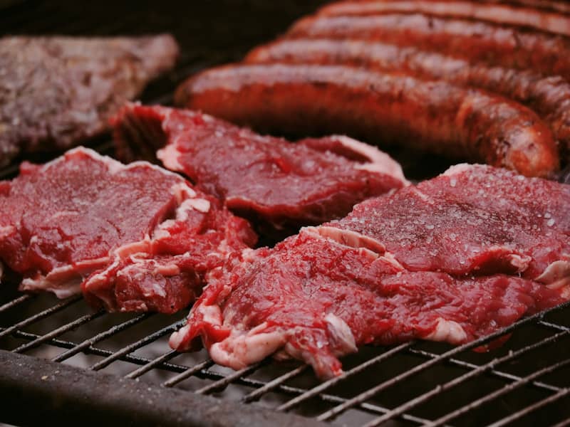 Meat and sausages grilling on a barbecue.