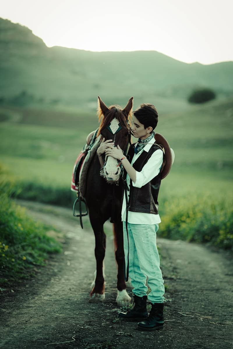 Young person with a horse in a rural setting