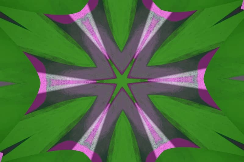 A kaleidoscopic flower-like shape in green and purple.
