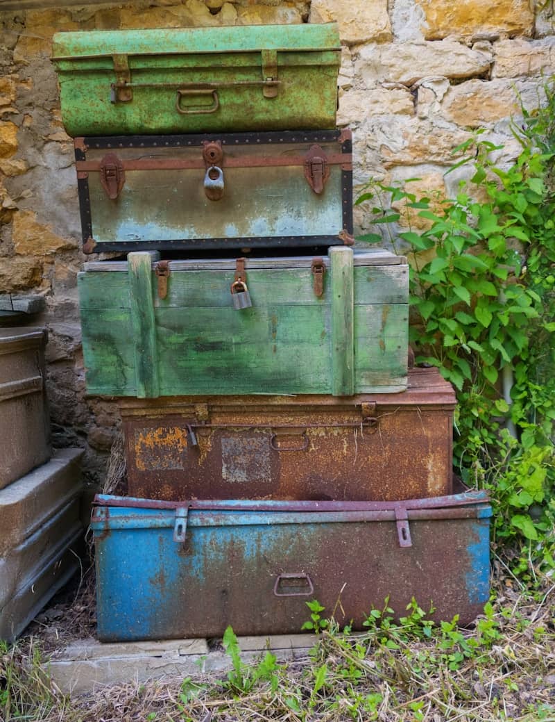Stacked, weathered chests show signs of age.