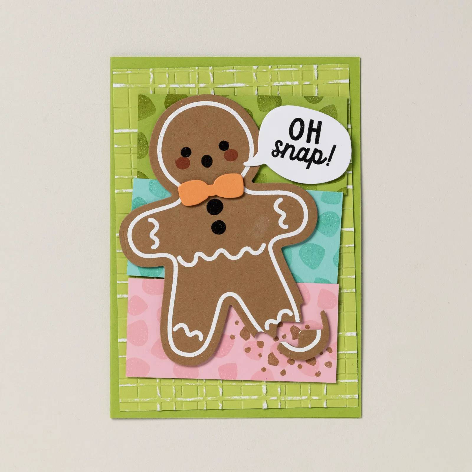 a handmade card with a gingerbread man that has a broken leg.  the sentiment says "oh snap"
