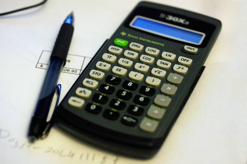 A calculator, pen, and documents for a test.