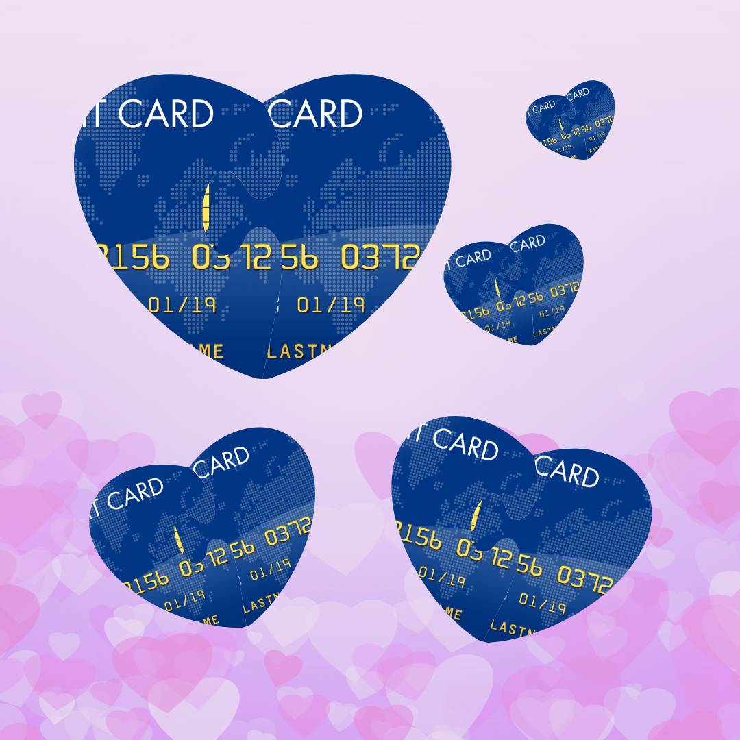 Blue credit cards in the shape of hearts on a pink background with darker pink hearts faded into the backdrop. 