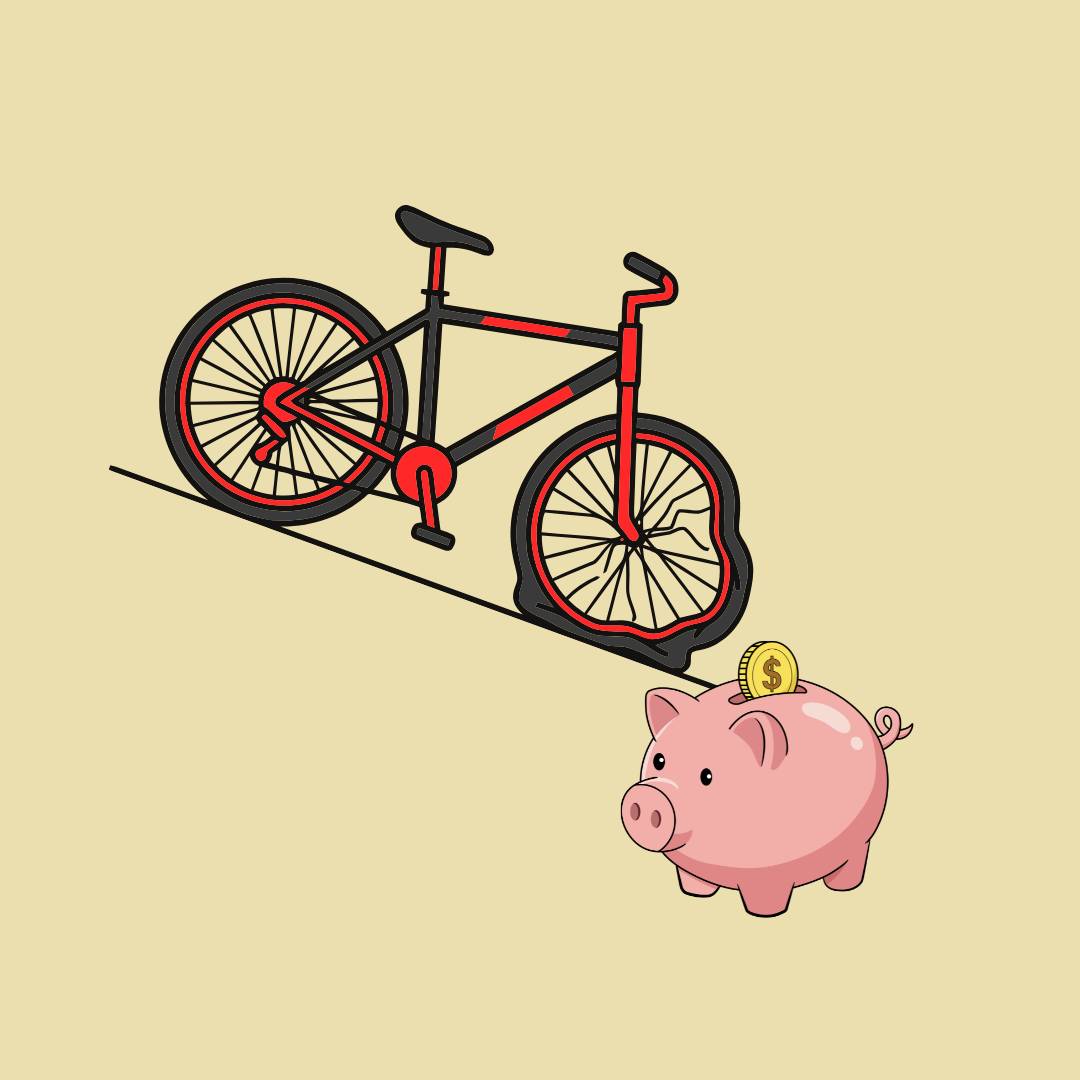 Red bike with flat tire and piggy bank next to it 