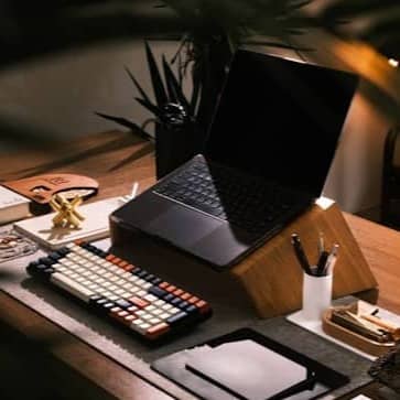 A modern desk setup with laptop and books.