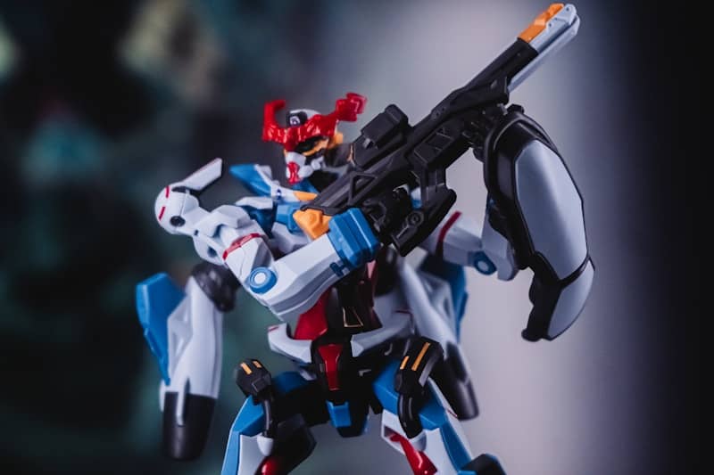 A futuristic robot with a weapon is posed.