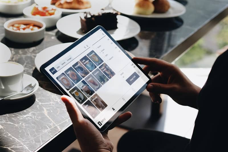 A person sitting at a table with a tablet