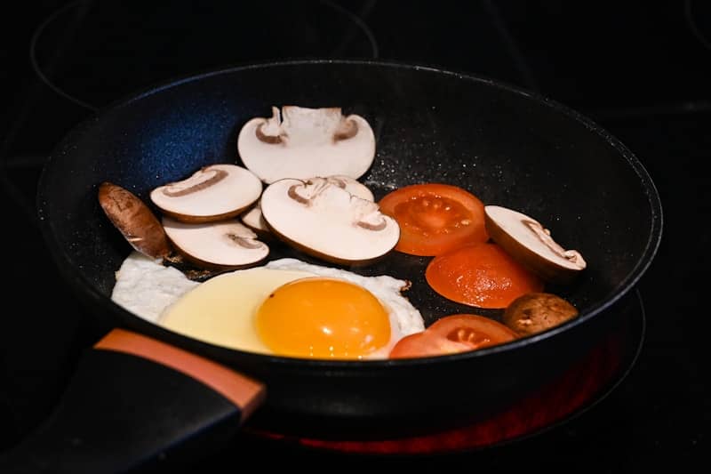 A frying pan filled with mushrooms and eggs