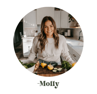 Molly standing at the counter in her kitchen with a cutting board full of veggies