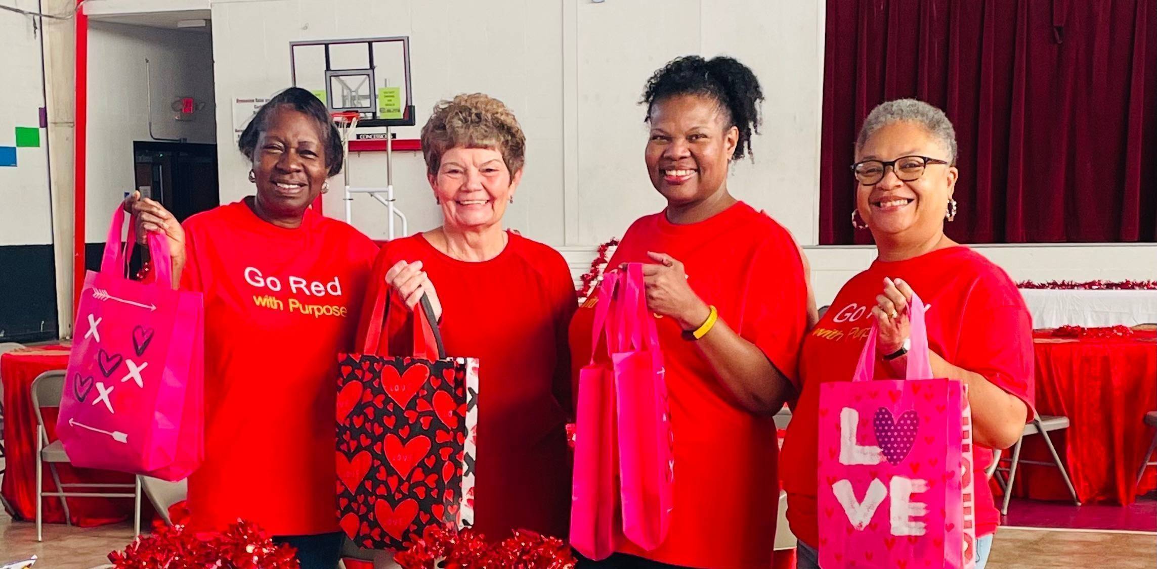 WHFitness ladies, myself and Mrs. Barbara Sims holding door prize bags she donated with the word love on them.