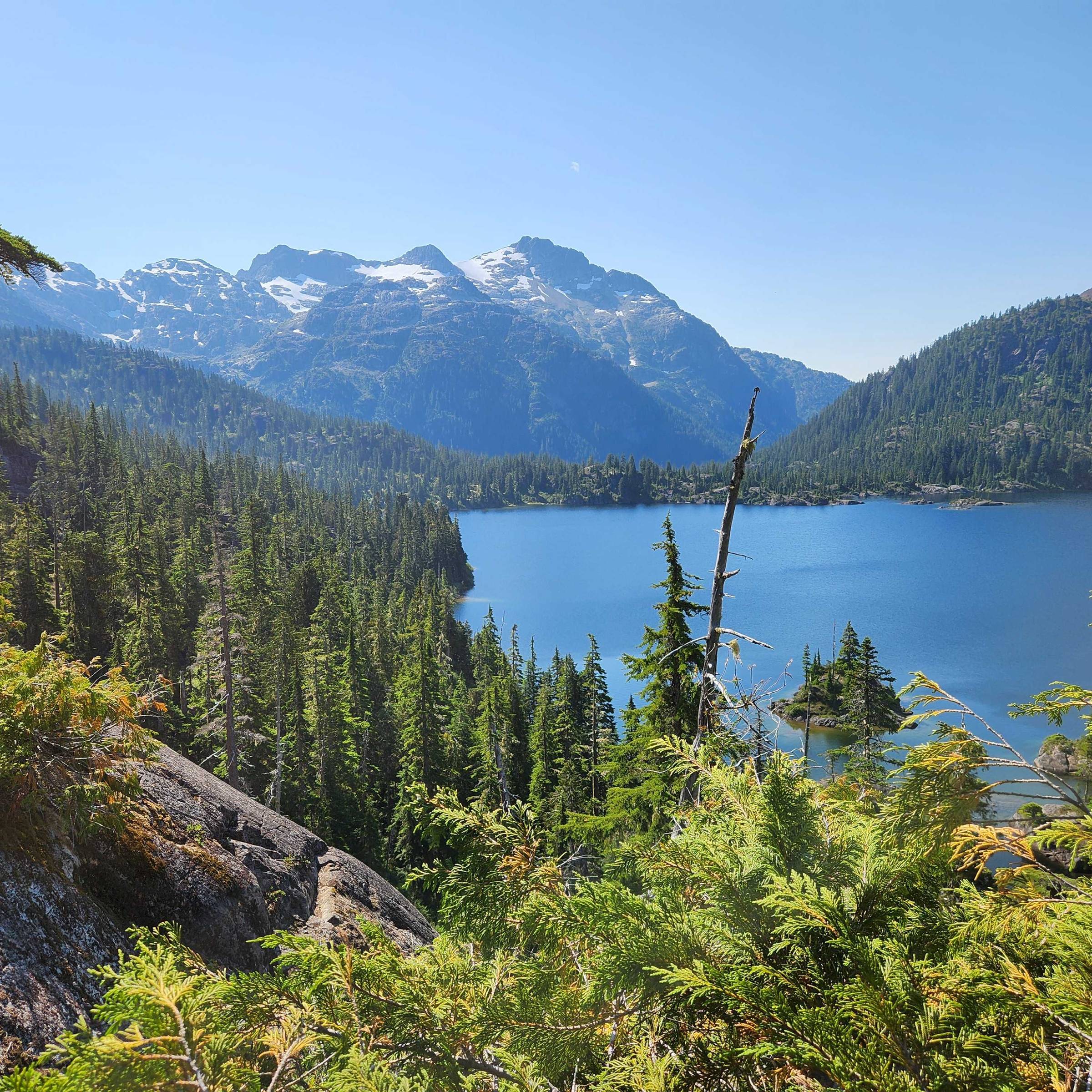 Lake view with snow capped mountain in Strathcona Provincial Park