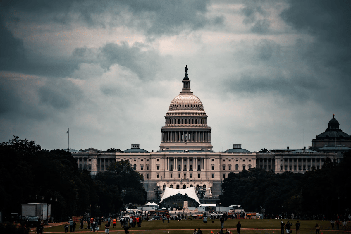 Capital Hill building with grey clouds in the background, best stocks to buy, learn a trade