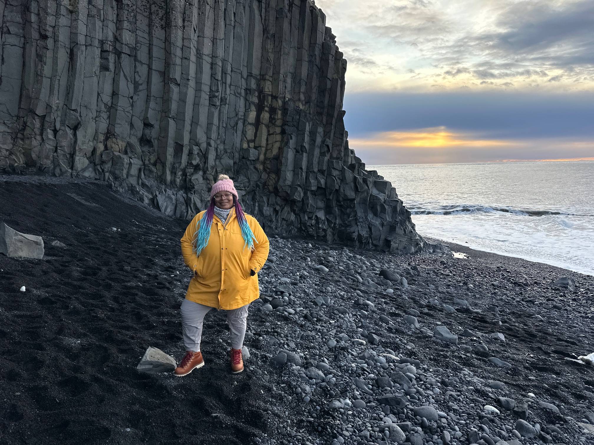 Annette posing near a basalt pillars at Reynisfjara Black Sand Beach in Iceland
