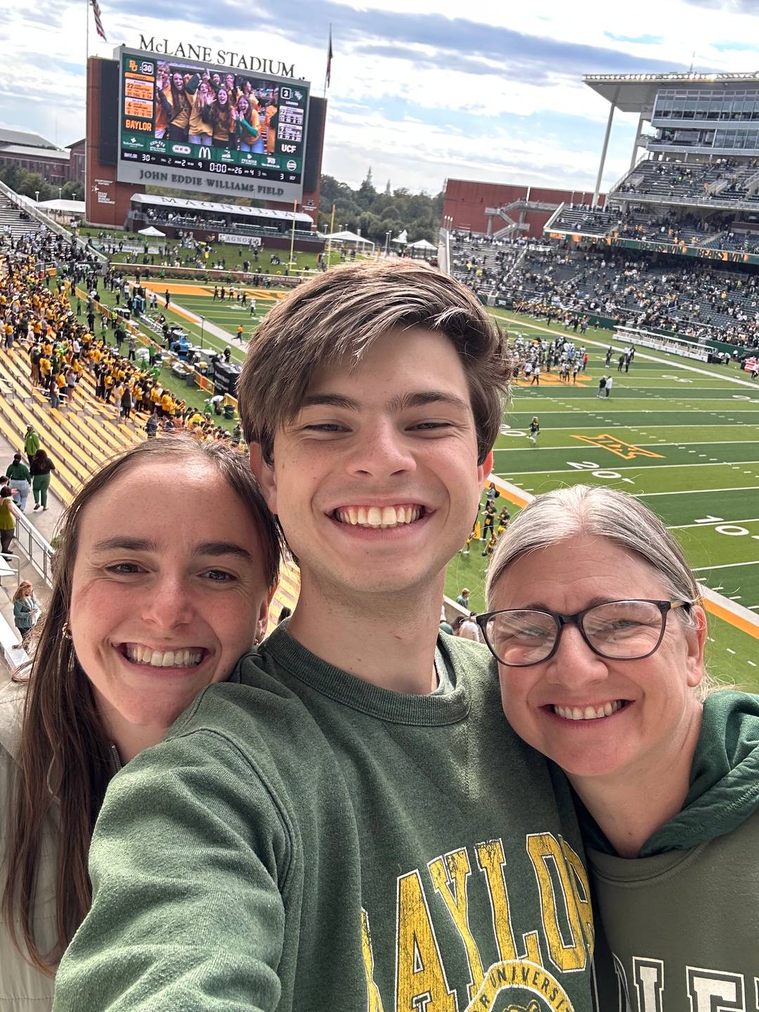 Sammy is with Josh and Emily after a Baylor football win. 