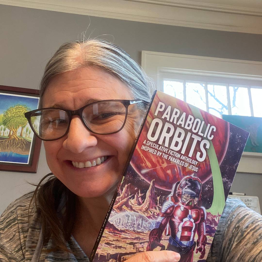 Sammy holding a copy of Parabolic Orbits. 