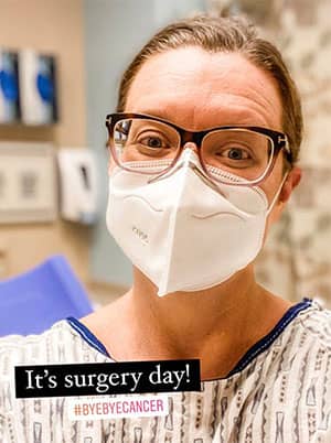 Me, Jeane, wearing my mask and sitting in my lovely hospital gown waiting to go into surgery in 2021.