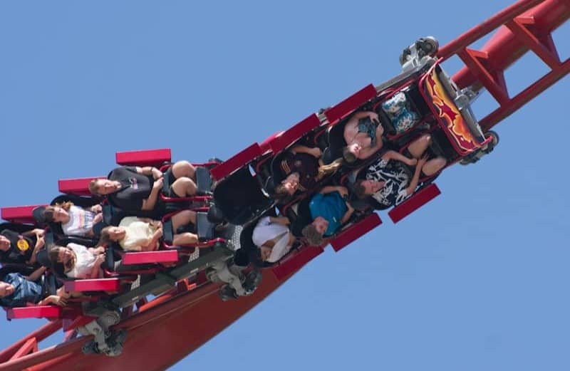 Roller coaster ascends high up a track.