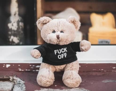 brown teddy bear on brown wooden table