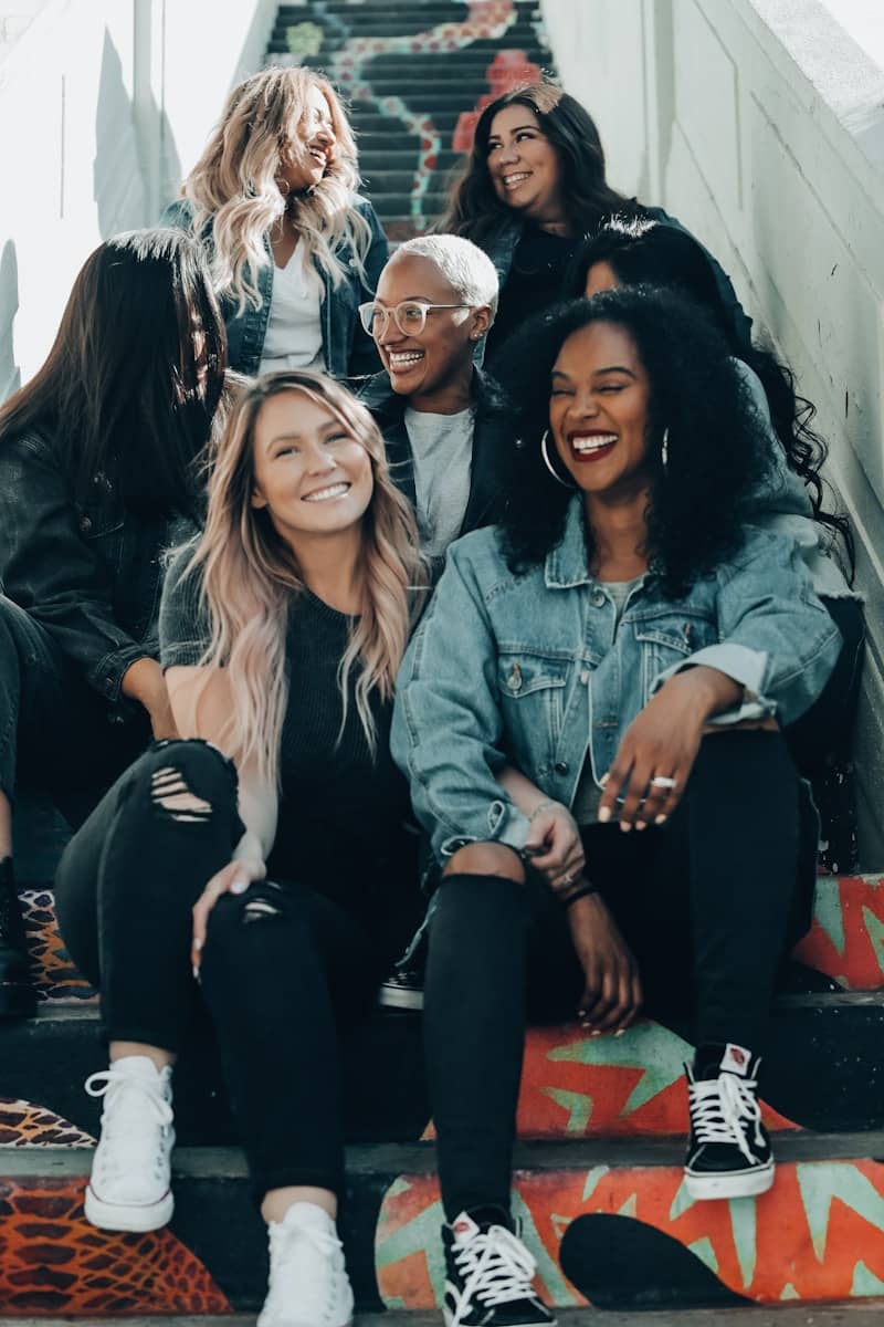group of women laughing on stairs