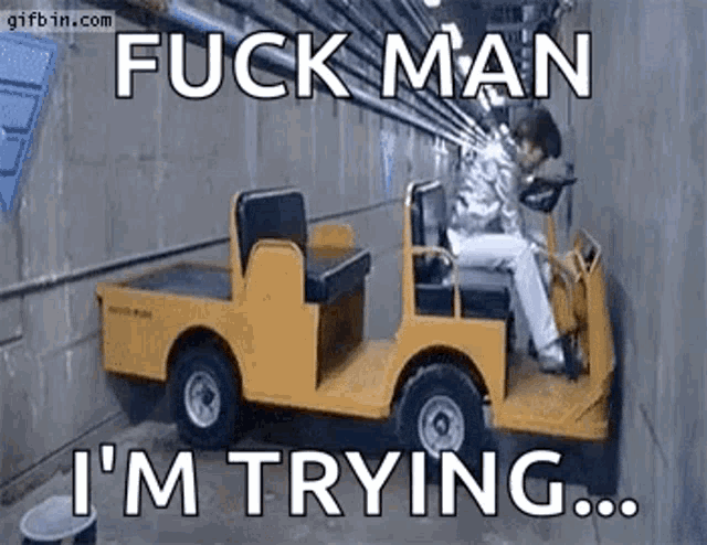 Gif of Austin Powers driving a cart stuck in a narrow corridor with text "Fuck Man, I'm trying..."