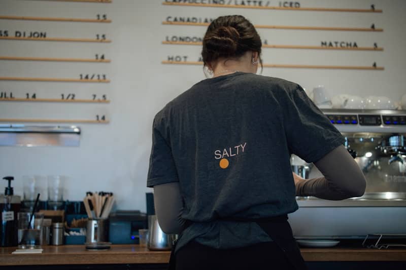 Barista working behind a coffee counter