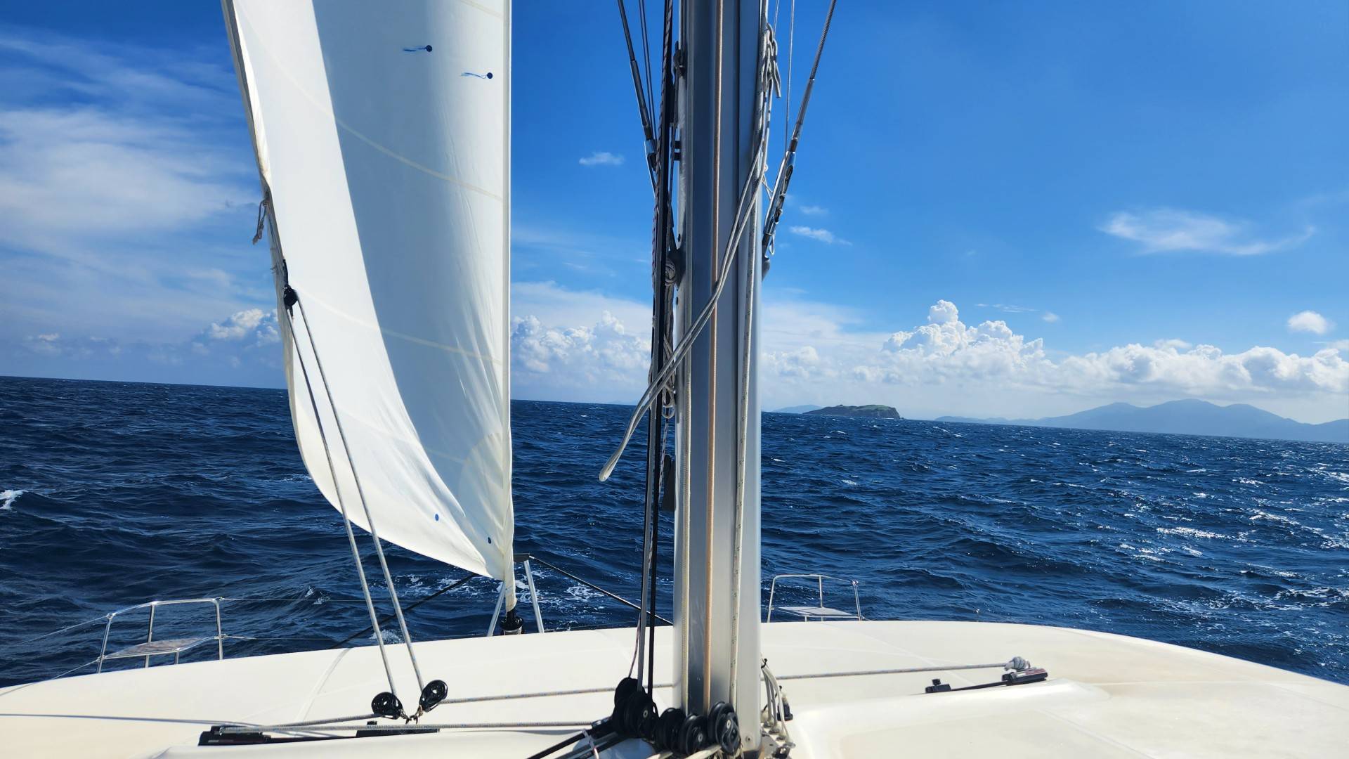 Reefed sails amidst strong trade winds on a recent bareboat trip