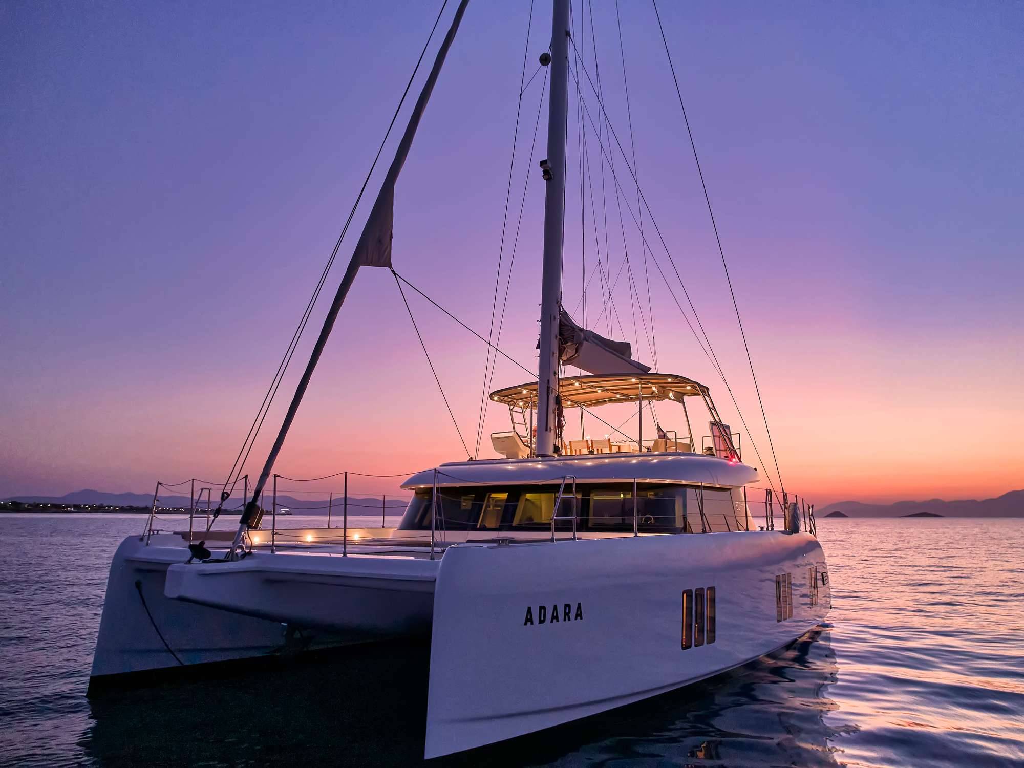 Adara at anchor in Greece, glowing in the soft evening light.