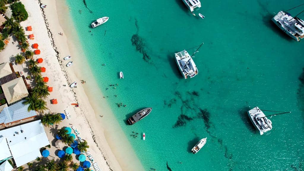 Sandy Spit: a tiny sandbar with a few palm trees, surrounded by classic Caribbean blue.