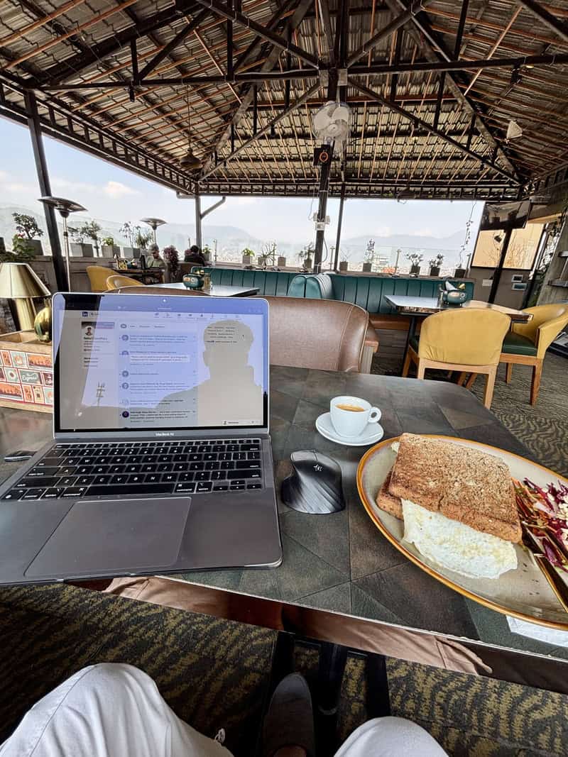 Laptop + breakfast on a table in Kathmandu