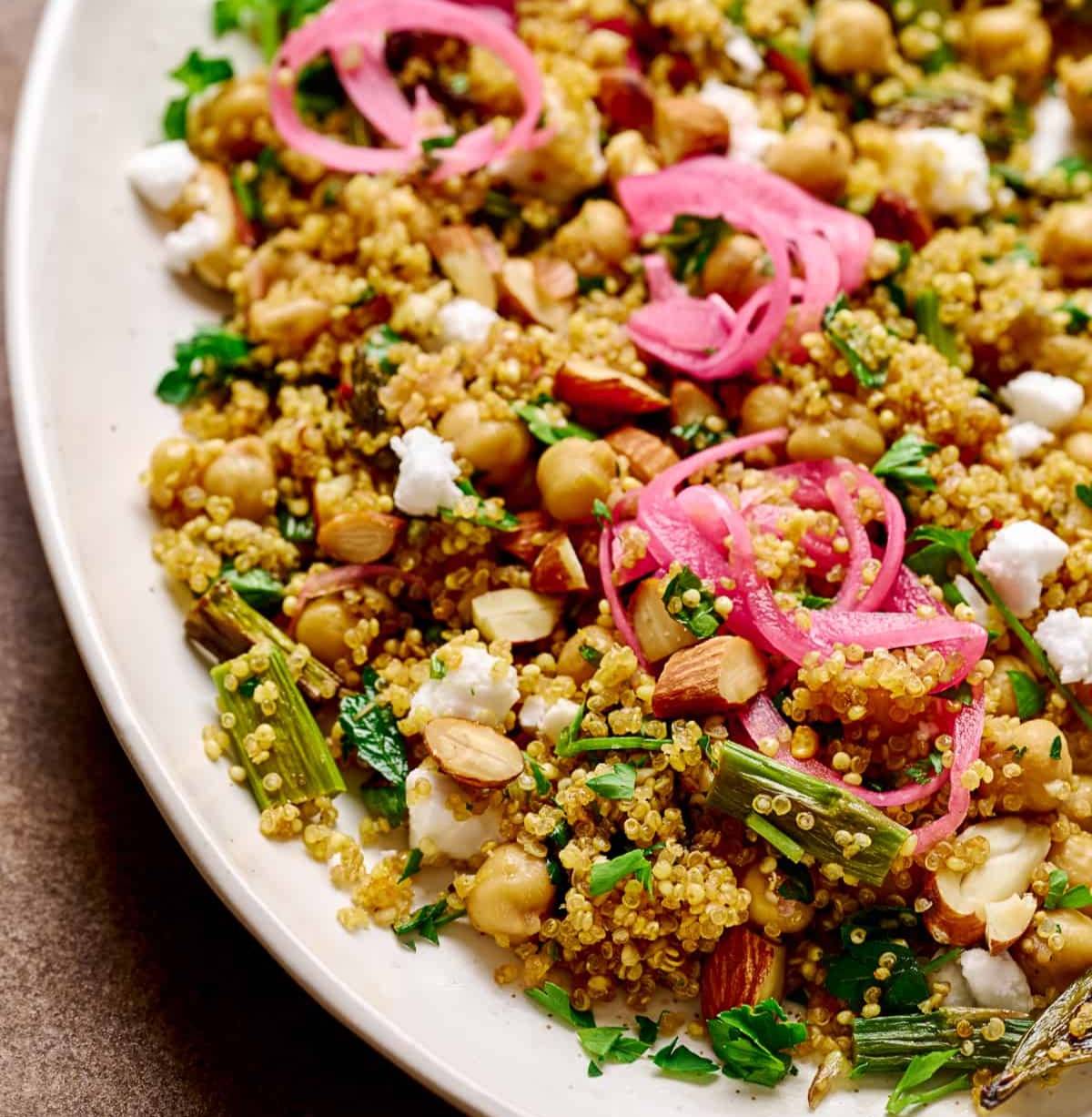 Close up photo of quinoa salad on a large white plate.