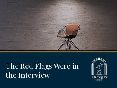 Empty leather chair spotlighted against a textured wall above navy banner reading 'The Red Flags Were in the Interview'