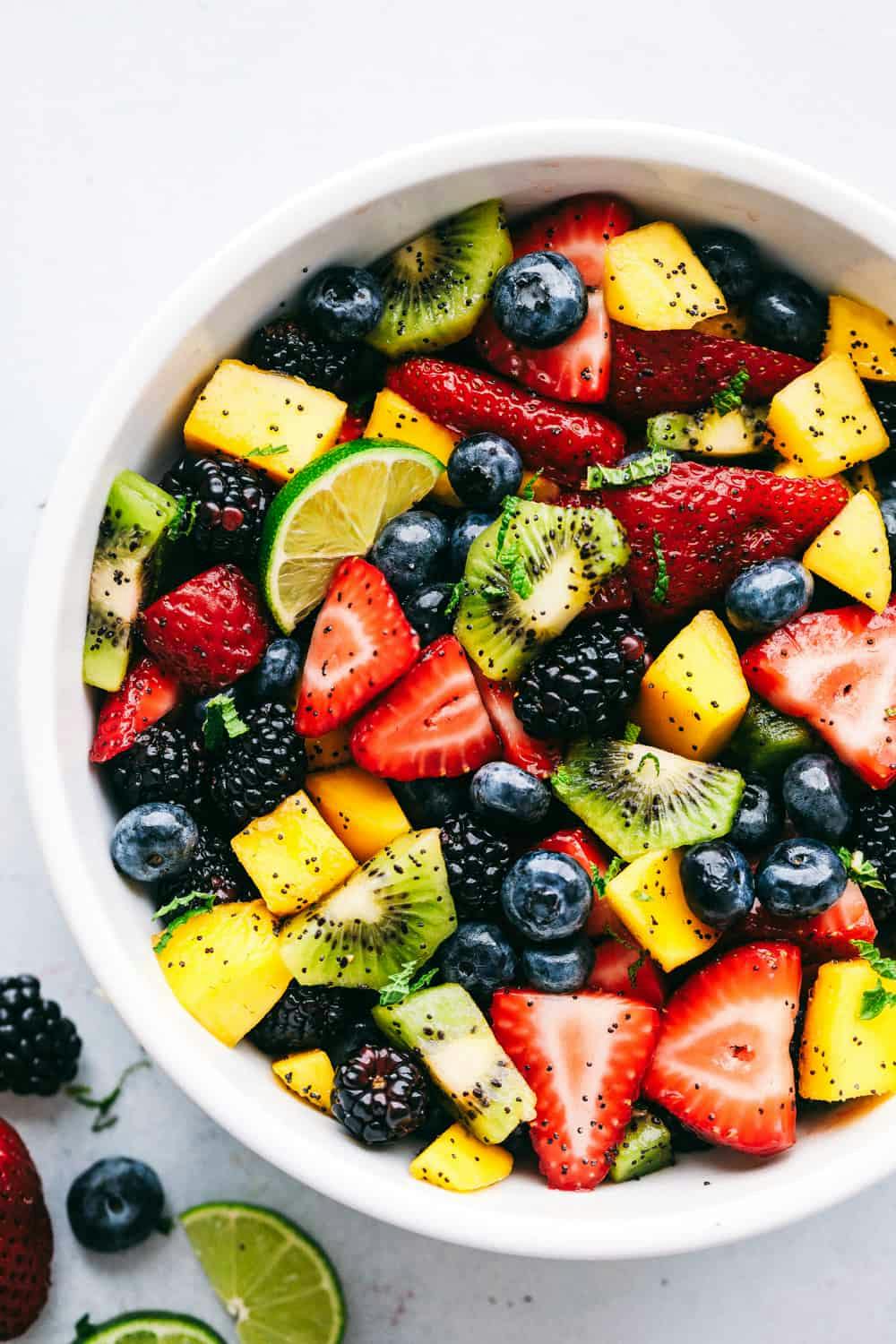 Fruit in a bowl garnished with a honey lime dressing. 