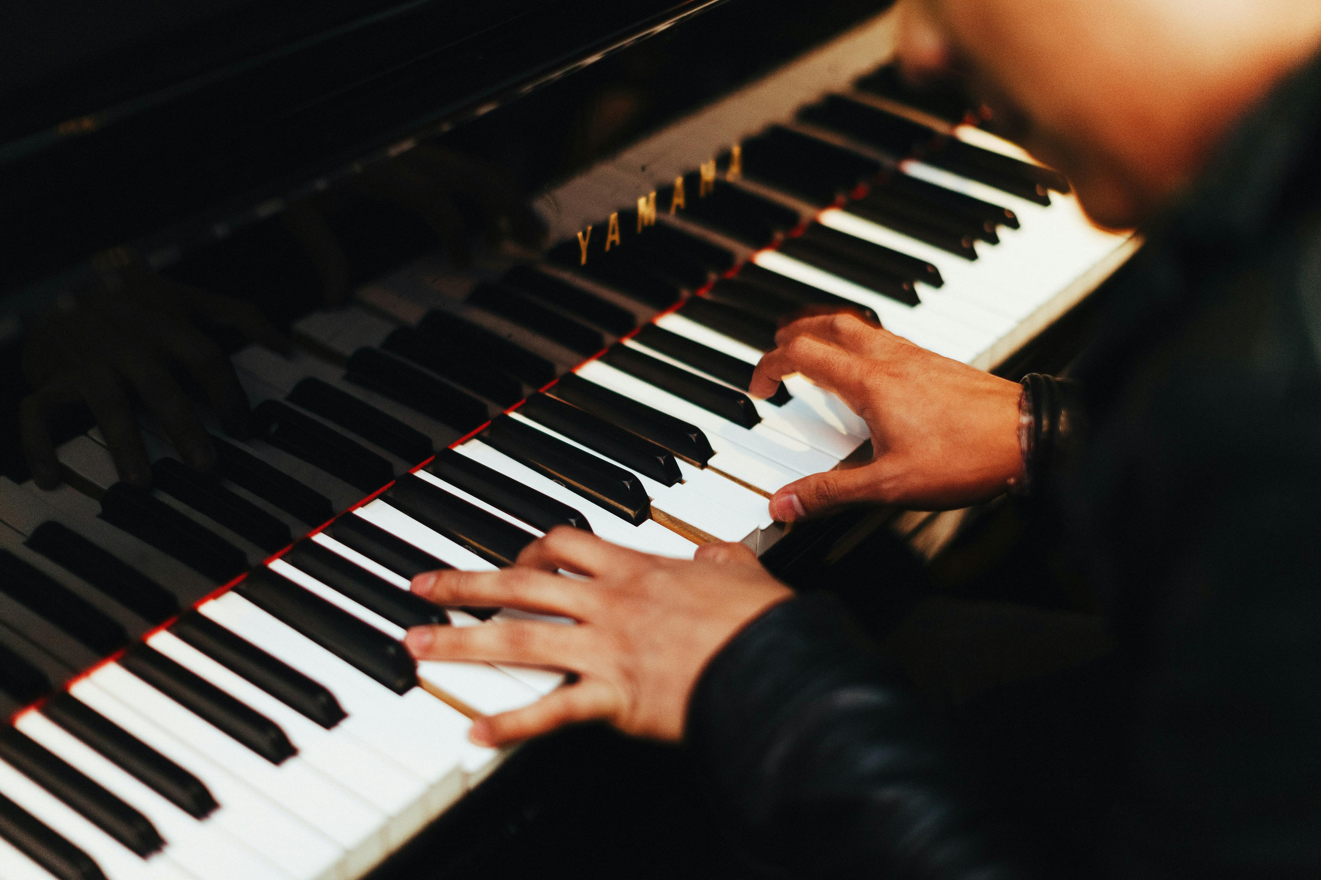 close up of person playing piano